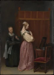 Giovane donna alla sua toilette con una serva